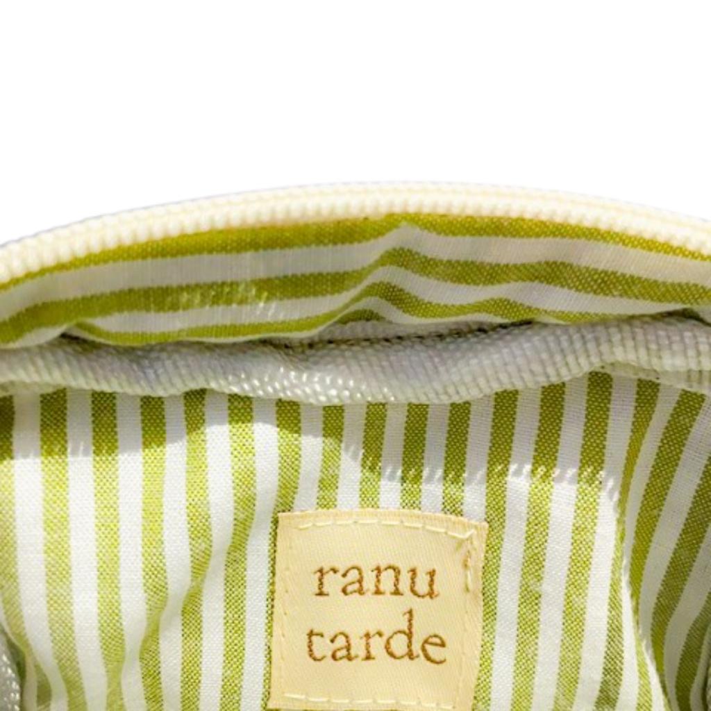 Interior of a ranu tarde Gingerbread Mini Pouch featuring green and white striped cotton lining and a brand label.