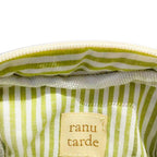 Interior of a ranu tarde Gingerbread Mini Pouch featuring green and white striped cotton lining and a brand label.